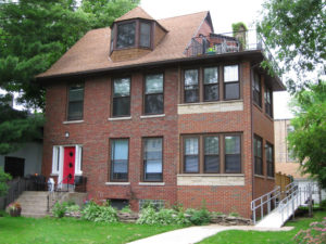 Harrison House: a brown house with a red door