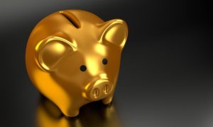 A gold piggy bank against a dark background