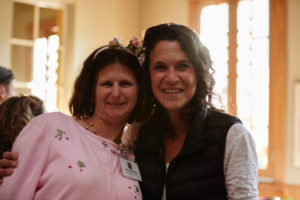 Photo of two women smiling, one a direct service professional and one a participant.