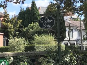 Photo of Aberdeen Lodge with large garden surrounding circular sign