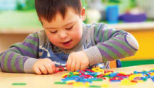 Student playing with puzzle pieces in colorful classroom setting