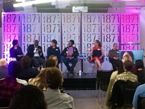 Panelists listen to each other speak on inclusive technology in Chicago on stage at 1871.