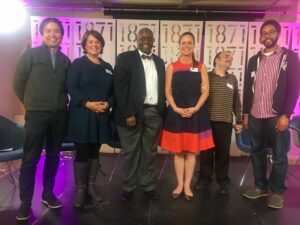 Panelists pose for a photo on stage after a successful and engaging event!