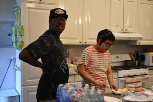 Two students prepare lunch at Hub 930.