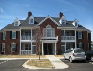 A large brown and white community housing option for individuals with disabilities.