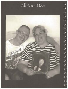 Carrie & her partner smile together on a couch in black and white photo