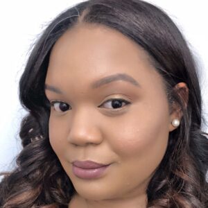 A Black woman smiles in headshot photo