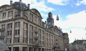 A large building in Amsterdam against a cloudy blue sky