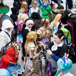 A crowd of people in costumes gather together.