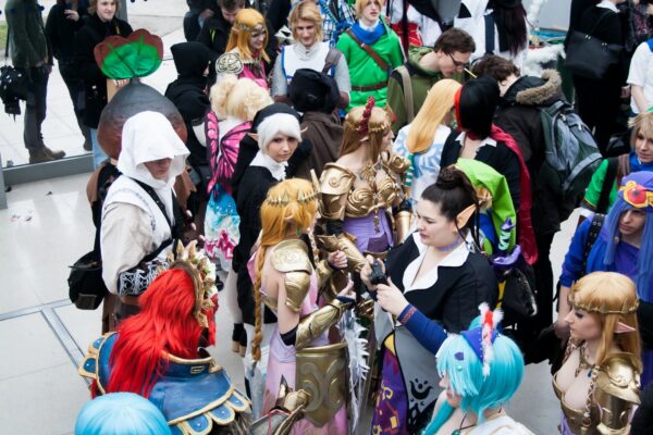 A crowd of people in costumes gather together.