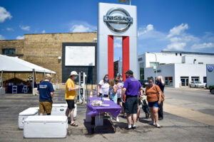 Participants check in and receive their meals at the drive-thru at Nissan Autobarn