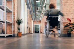 A person in a wheelchair moves down a hallway in action